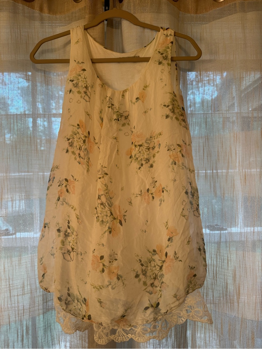 Tendenze silk top features a sheer floral overlay and a delicate lace hem